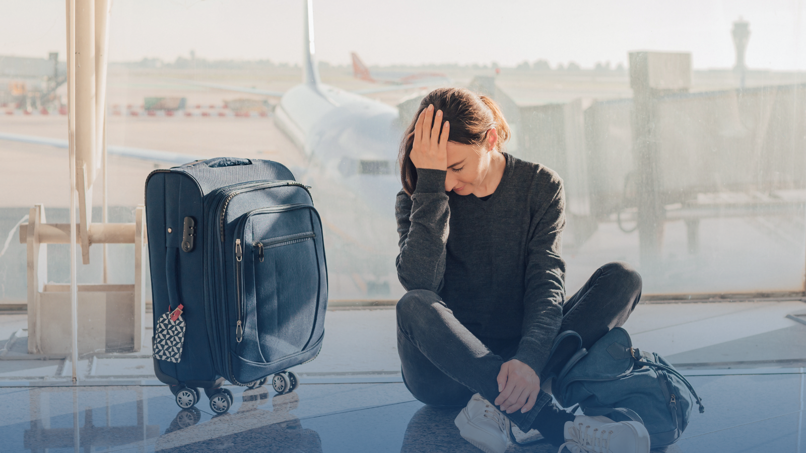 A passenger with a hand-luggage looking unhappy