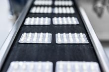 Capsule pills in blister pack on conveyor belt in a pharmaceutical industry production